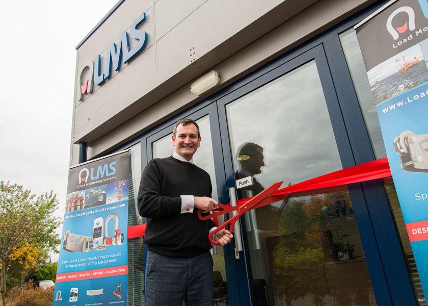 Cutting the ribbon at member’s new office - image